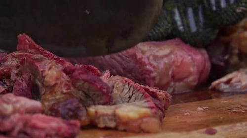 Chopping Diced Cooked Meat with a Metal Cleaver