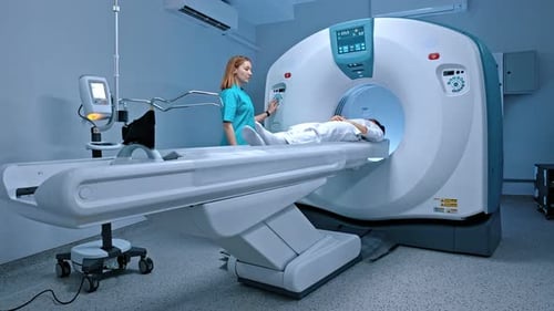 Patient Dressed Up in White Undergoes Magnetic Resonance Imaging Lying on CT or PET Scan Bed