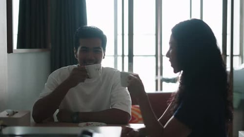Man and Woman Drinking Coffee Together Indoors