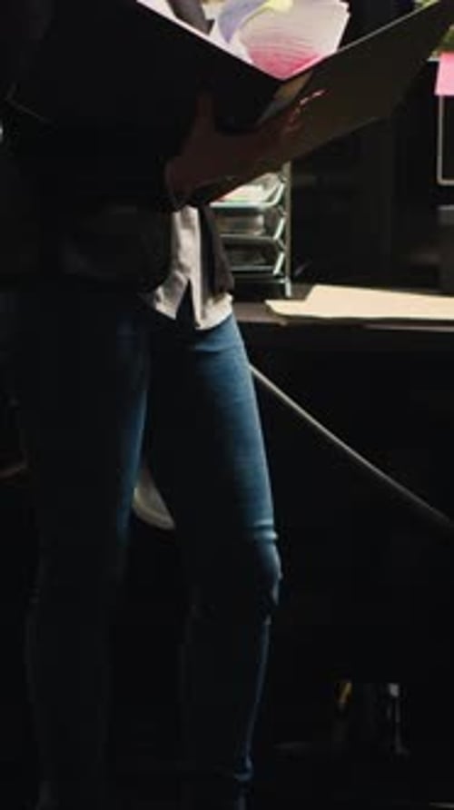 Woman Holding a File in an Office Setting