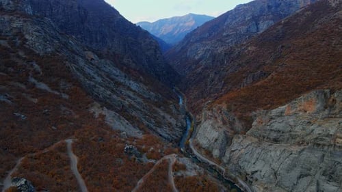 Aerial view the mountains are covered in trees and river in autumn season