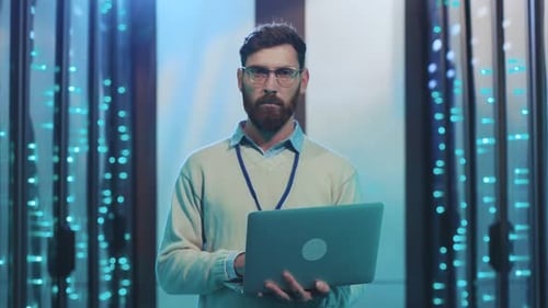 Data Center Technician Collaborating with Laptop in a CuttingEdge HighTech Environment