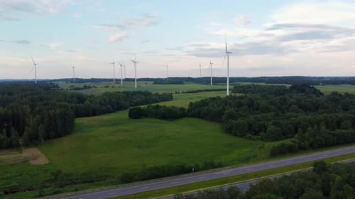 Wind Turbines in Green Countryside with Highway in Foreground
