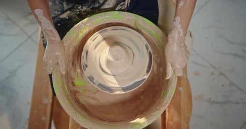 Potter's Wheel Pottery fait tourner un cadre au-dessus d'un homme crée anonymement un produit en argile