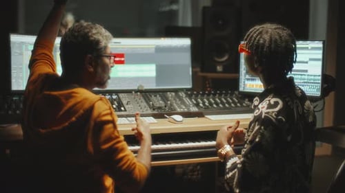 Sound Engineer Collaborating with Music Producer in Studio Control Room