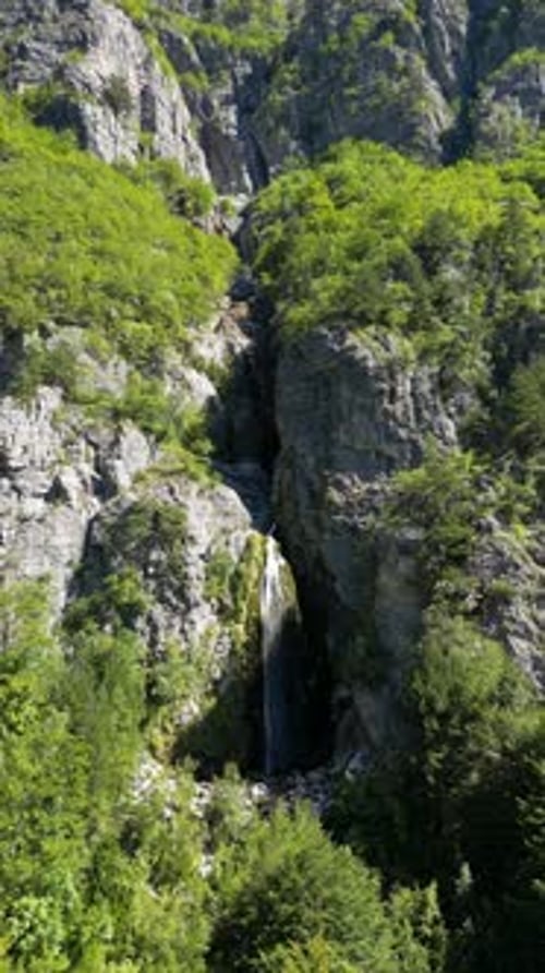 Vertical Drone Push-In Toward Grunas Waterfall in Theth, Albania