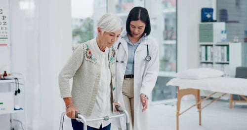 Senior Woman Practicing Walking with Doctor Assistance