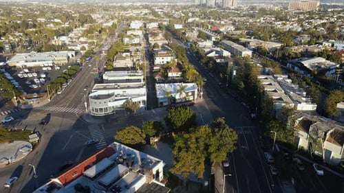 Aerial view overlooking the cityscape of Venice, golden hour in Los Angeles, USA - tilt, drone shot