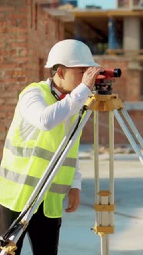 A Construction Surveying Professional Specializing in Leveling Instruments for Accurate Measurements