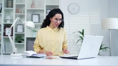 Woman in Video Conference on Laptop at Desk