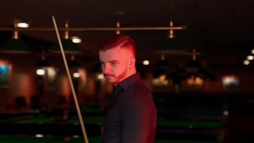Man Standing With Pool Cue in Billiards Room