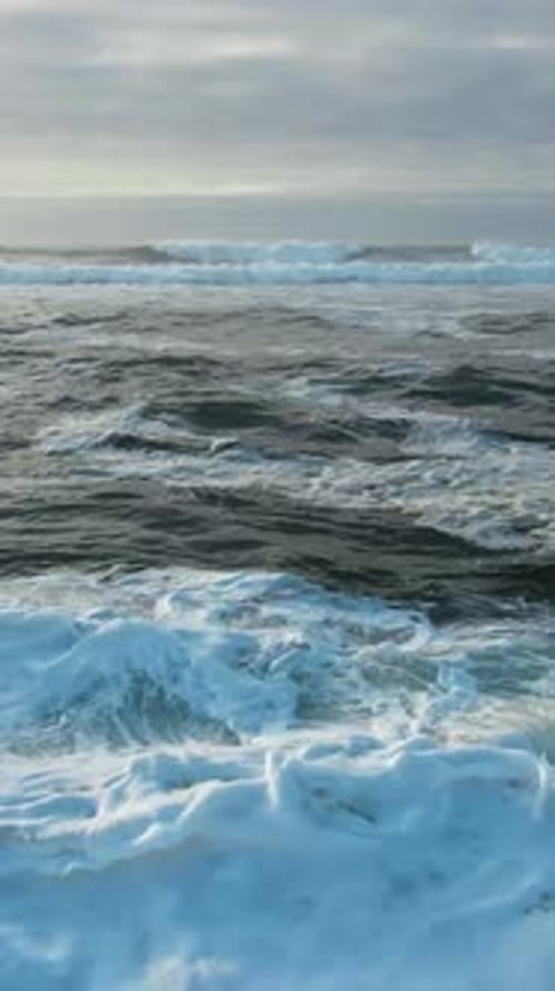 Flying Over Sea Waves on Cloudy Day Vertical Video