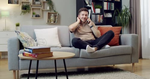 Man Chatting on Phone While Relaxing on Couch