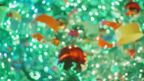 Blurred New Year Christmas Tree Flashing Blue and Green Garland Lamps Lights Bokeh Background