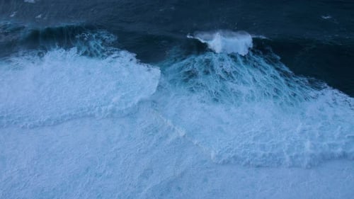 Dark ocean with large, turbulent waves in madeira at night dark blue water contrasts with the white