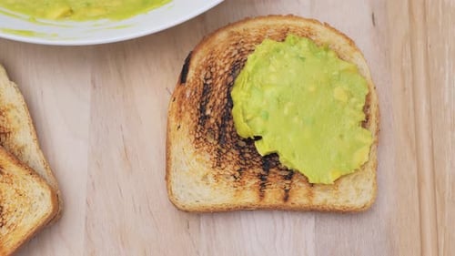Spreading Avocado on Toast