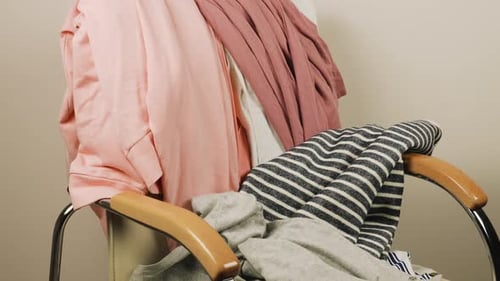 Chair piled with clothing