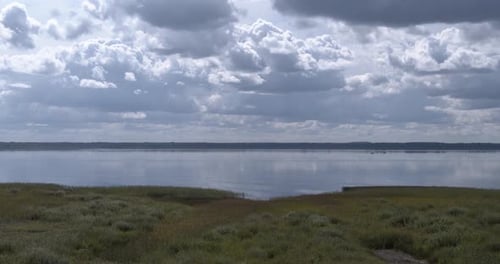 Summer clouds over lake time lapse