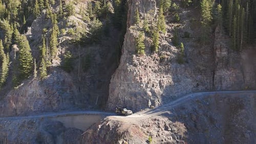 Aerial view of a vehicle on a mountain road, USA.