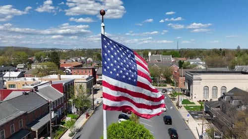 American Flag Waving Over a Quaint Town