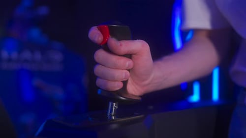 Engaging Joystick Control Gameplay Demonstration in a Vibrant Arcade Setting