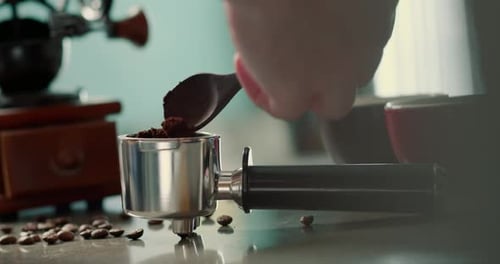 Man Pouring Ground Coffee View Hand From a Wooden Spoon Pours Ground Coffee Into a Coffee Brewing