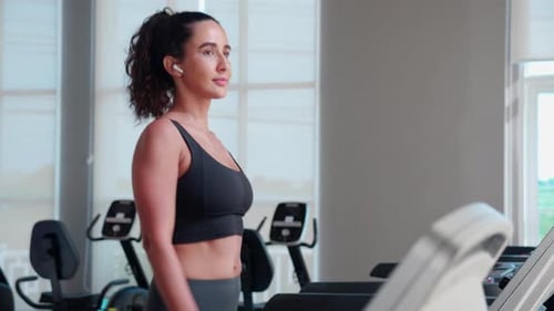 Young woman workout with walking and exercise on machine treadmill in fitness gym sport.