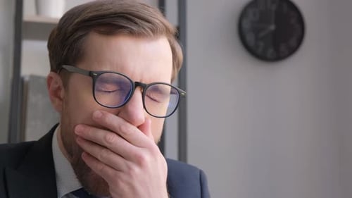 Close Up Face of Tired Manager Yawning at Work While Using Laptop Businessman Looking Exhausted