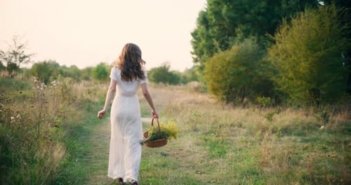 Smiling Girl Walks Through Tall Summer Grass