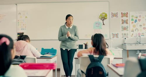 School, education and children with hand raised in classroom for lesson