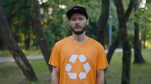 Adult Man Wearing a Recycling Shirt in Park