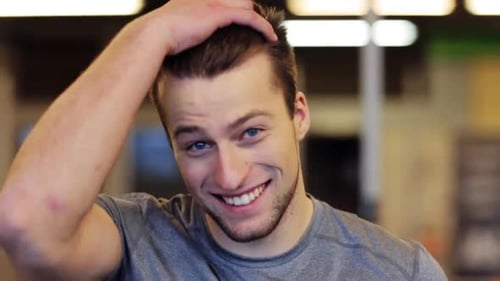 Smiling Young Man with Brown Hair Posing