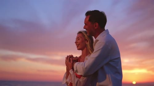 Loving Couple Embracing on the Beach at Sunset