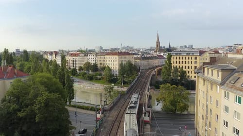 Subway Train Crosses River in Beautiful European City. Aerial View
