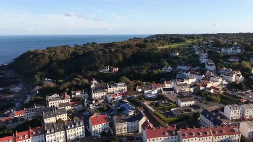 High panning footage of St Peter Port Guernsey out to sea from town Val de Terres,clear waters of