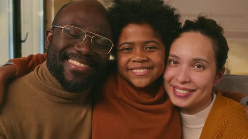 Loving Family Smiling Together Indoors