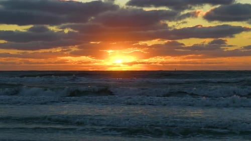 Evening Landscape of Sea Water Waves Crushing on Sandy Beach at Sunset