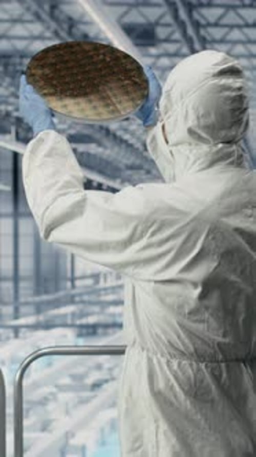 Vertical Video Evaluating Silicon Wafer Prototype Engineering and Team Analyzing Microchips