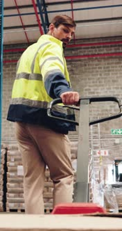 Construction, warehouse and back of man with trolley for supply chain, logistics and distribution