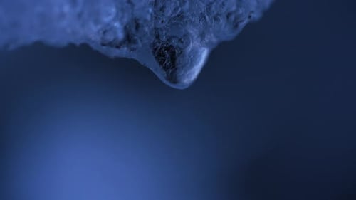 CloseUp of Water Droplet Suspended From Ice Macro Shot of Melting Ice