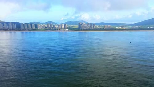 Aerial Top view of a transparent blue sea with beautiful waves at sunny day in summer. air of ocean