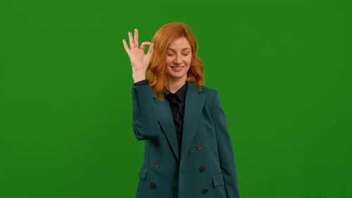 Positive smiling woman on green screen background showing double okey sign.