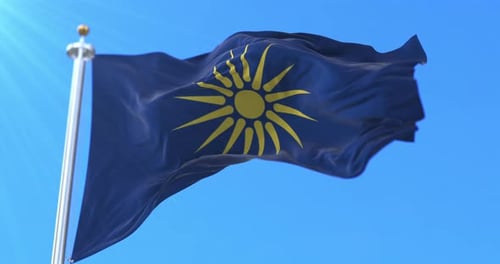 Blue Flag with Yellow Sun Symbol Waving in Wind