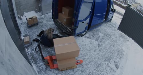 Male Porter Falls Hard on Ice While Unloading Parcels From Van and Cannot Stand