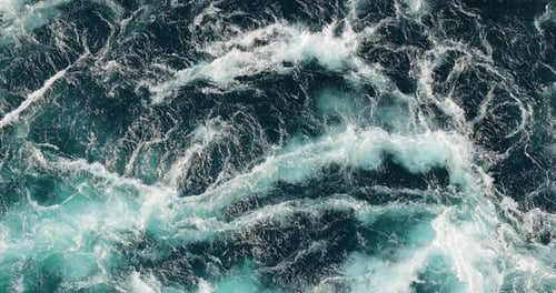Blue waves of water of the river and the sea meet each other during high tide and low tide.