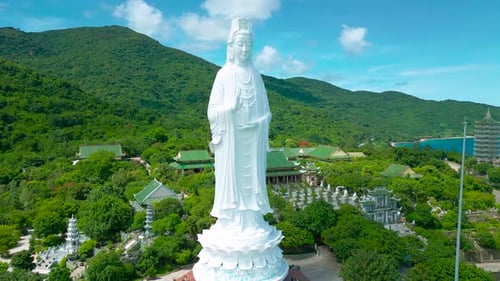 A Stunning View of the Lady Buddha Statue in Da Nang Overlooking the Serene Ocean and Lush Greenery