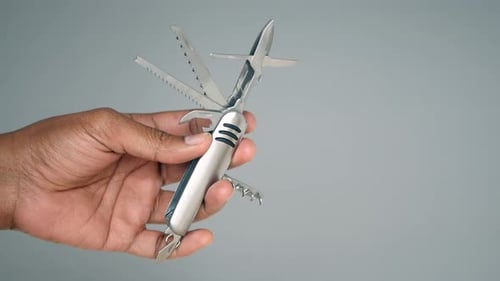 Hand Holding Silver Multi-Tool