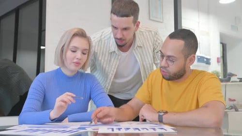 Team Analyzes Data at Bright Modern Workplace