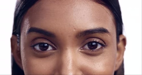 Portrait, eyes and beauty with a woman closeup in studio isolated on a white background looking