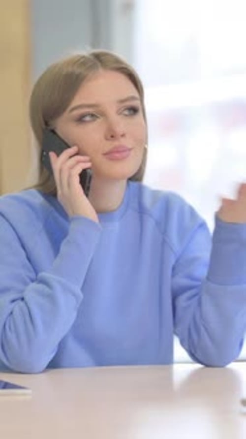 Woman Talking on Phone in Office, Vertical Video